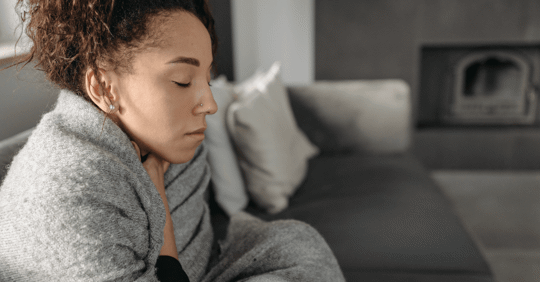 Woman bundled up in blanket