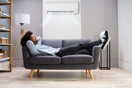 happy man lying on couch under hvac