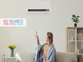 Woman Adjusting HVAC Unit